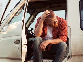 Driver of the car is sitting thinking about something