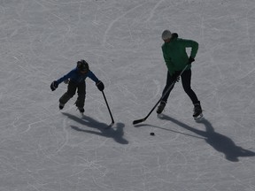 A mother and her son practice on an ice pad on the frozen surface of Lake Louise in Lake Louise, Alta.