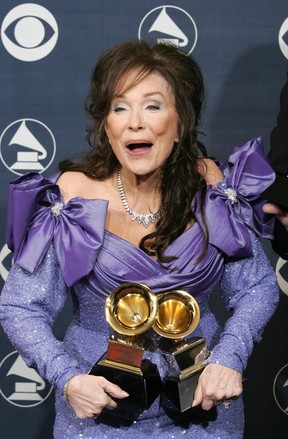 Country legend Loretta Lynn poses with the awards she won at the Grammys ceremony in Los Angeles 13 February 2005.