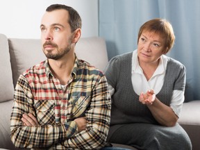 Aged mother argues with her adult son at home.