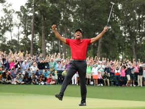 Tiger Woods celebrates on the 18th hole after winning the 2019 Masters at Augusta National Golf Club in Augusta, Georgia, U.S.  April 14, 2019.