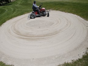 The maintenance crew prepare Carruthers Creek Golf & Country Club for opening on Wednesday, May 13, 2020.