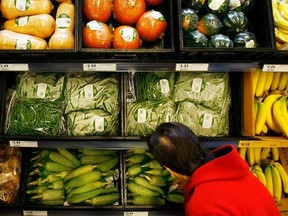 A shopper selects from pre-packaged produce at a Fresh & Easy grocery as Tesco PLC.