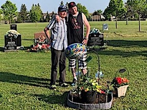 Dan Davis Jr. (right) and Sr., visit the gravesite of Keagan Davis on Monday.