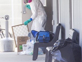 A person in full PPE collects an air filter.
Ontario is trying to "water down" guidelines that give health-care workers in long-term care homes access to N95 masks, the union representing them said Friday, while Premier Doug Ford insisted protective equipment is available to the workers.