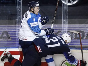 Dylan Larkin of the US, right, checks Finland's Mikko Lehtonen during the Ice Hockey World Championships group A match between the United States and Finland in 2019.