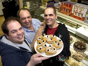 The late Sal Mucio Sr. (middle) holding a plate of his famous zeppoles with two of his three sons, Francesco (left) and Sal Jr. (right) at Messina Bakery.
