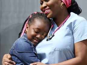 Birgit Umaigba and her eight-year-old daughter, Emmanuela, on Friday, May 8, 2020. Umaigba is a registered nurse and was exposed to the novel coronavirus on the job. She had to be isolated for two weeks, but has since returned to work.