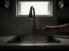 Vicky Marshall, a resident on Bayview Ave. in the community of Booth's Harbour in St. Williams, Ont. turns on her kitchen faucet, Tuesday, September 3, 2019. Marshall, who was also running her washing machine, demonstrated that water will only trickle out of her kitchen faucet if she uses water in another area of her home. Approximately 100 private residents who's water is controlled by the owner of Booth's Harbour are complaining of poor water conditions, including negative water pressure, a bleach smell to their water and a lack of water testing for lead.