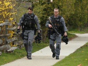 Heavily armed Peel Regional Police tactical officers on the scene at Holden Cr. and Hassall Rd. after a violent chain of events that began with a collision at Cawthra Rd. south of Burhamthorpe Rd. and saw three people stabbed before it ended with a police-involved shooting on Saturday, May 2, 2020.