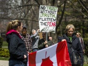 People gather at Queen's Park, to protest against the COVID-19 shutdown, in Toronto, Ont. on Saturday, April 25, 2020.