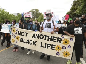 Thousands of protesters packed Christie Pits Park, then marched along Bloor St. W. and on to Toronto Police Headquarters demanding justice for Regis Korchinski-Paquet -- a 29-year-old woman with mental health issues who fell to her death from a High Park balcony Wednesday after officers responded to an assault call -- on Saturday May 30, 2020.