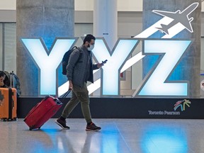 A passenger walks through Pearson airport.