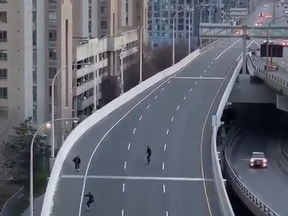 Three skateboarders ride on the Gardiner Expressway in a screengrab from video.