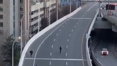 Three skateboarders ride on the Gardiner Expressway in a screengrab from video.
