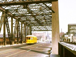 Though officially titled the Sir Isaac Brock Bridge (in honour of the British army officer and hero of the War of 1812, a dedication done through the efforts of the late local historian Stephen Otto), this landmark structure will be closed to all vehicular and streetcar traffic starting Monday. All bridge superstructure and deck rehabilitation as well as TTC track, overhead and pole replacement, plus road resurfacing is to be completed by year's end. In this 1964 view from the Transit Toronto collection the TTC's W-28 Rail Grinder makes its way south on Bathurst St. to Fleet St. and the waterfront. W-28 was built in 1917 as a passenger streetcar for the Toronto Civic Railway. It was acquired by the TTC, converted to a work car and retired in 1976. It is presently part of the operational fleet of the Halton County Radial Railway (see HCRY.org)