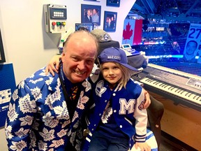Six-year-old busker Max keys with Maple Leafs organist Jimmy Holmstrom.