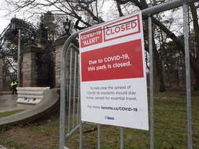 Police stand guard Toronto's High Park entrances after the Mayor of Toronto declared the park to be closed to prevent further spread of COVID-19 amongst the public.