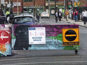 Active TO program on Kensington in  Kensington Market area restricting traffic in an attempt  to provide more space for people on this Victoria Day weekend.  Friday May 15, 2020.