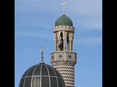 A pair of Muslim men prepare the minaret at the Madinah Masjid mosque on Danforth Ave. west of Greenwood Ave. for the evening Adhan call to prayer just before dusk as part of Ramadan on Sunday May 3, 2020. Jack Boland/Toronto Sun/Postmedia Network