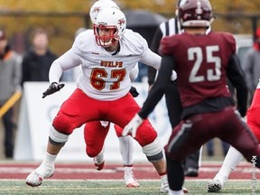 Offensive lineman Coulter Woodmansey sets up to block for the Guelph Gryphons during a USports game last season. The first-round CFL pick will be doing his blocking now for the Hamilton Tiger-Cats.