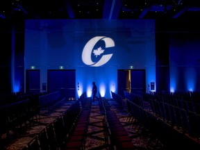 A man is silhouetted walking past a Conservative Party logo before the opening of the Party's national convention in Halifax on Thursday, August 23, 2018. Richard Decarie, a social conservative whose views were widely condemned by some senior Conservatives, has been barred from running the party's leadership race.