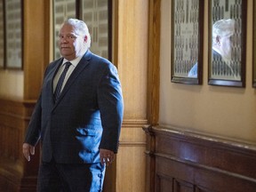 Premier Doug Ford leaves his office at Queen's Park to deliver his daily news briefing.