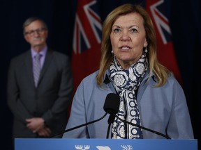 Ontario Chief Medical Officer of Health Dr. David Williams looks on as Ontario Health Minister Christine Elliott speaks during the daily briefing at Queen's Park in Toronto on June 18, 2020.