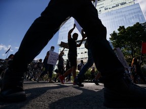 Protestors march during an anti-racism protest in Toronto on June 6, 2020.