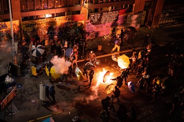 SEATTLE, WA - JUNE 08: Demonstrators clash with police near the Seattle Police Departments East Precinct shortly after midnight on June 8, 2020 in Seattle, Washington. Earlier in the evening, a suspect drove into the crowd of protesters and shot one person, which happened after a day of peaceful protests across the city. Later, police and protestors clashed violently during ongoing Black Lives Matter demonstrations following the death of George Floyd.