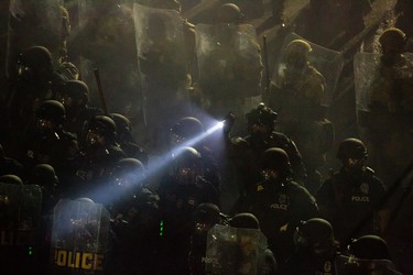 SEATTLE, WA - JUNE 08: Seattle Police and Washington National Guard personnel retake control of an intersection as demonstrators clash with law enforcement near the Seattle Police Departments East Precinct shortly after midnight on June 8, 2020 in Seattle, Washington. Earlier in the evening, a suspect drove into the crowd of protesters and shot one person, which happened after a day of peaceful protests across the city. Later, police and protestors clashed violently during ongoing Black Lives Matter demonstrations following the death of George Floyd.