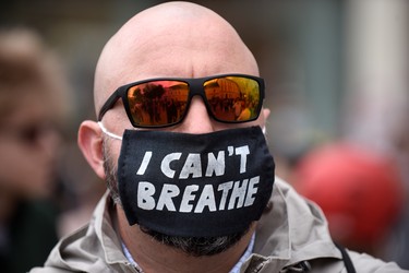 A protester wearing a face mask reading 'I can't breathe' during a Black Lives Matter march on June 04, 2020 in Vienna, Austria. The death of an African-American man, George Floyd, while in the custody of Minneapolis police has sparked protests across the United States, as well as demonstrations of solidarity in many countries around the world.