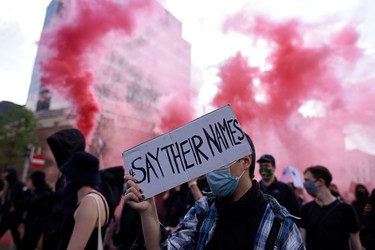 A protester holds up a sign reading '#saytheirnames' during a Black Lives Matter march on June 04, 2020 in Vienna, Austria. The death of an African-American man, George Floyd, while in the custody of Minneapolis police has sparked protests across the United States, as well as demonstrations of solidarity in many countries around the world.