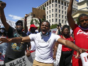 People attend a rally at the edge of Lafayette Park across the street from the White House during protests over the death of George Floyd on June 7, 2020 in Washington, D.C.