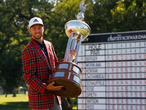 Daniel Berger of the United States celebrates with the plaid jacket and Leonard trophy after defeating Collin Morikawa of the United States in a playoff during the final round of the Charles Schwab Challenge.