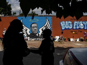 Mourners photograph a mural of George Floyd, whose death in Minneapolis police custody has sparked nationwide protests against racial inequality, in Houston, Texas, U.S. June 8, 2020.