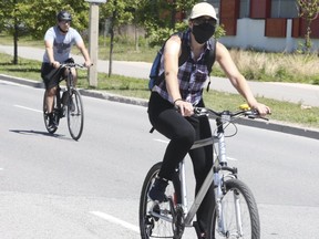Masked cyclists enjoy the outdoors as they take advantage of ActiveTO on June 14, 2020.