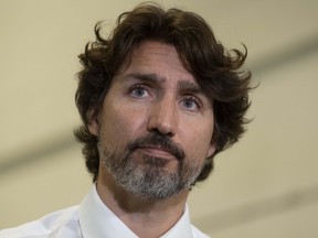 Prime Minister Justin Trudeau listens to a question during a news conference following a visit to a business in Ottawa, Thursday June 11, 2020.