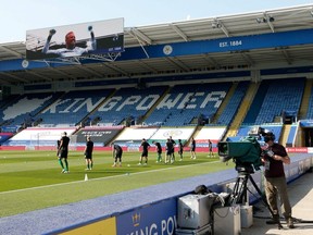 Brighton's players warm up in an empty stadium prior to their team's match against Leicester City on June 23, 2020, in Leicester, England.