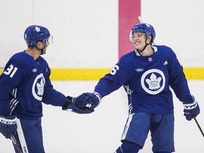 Mitch Marner celebrates a goal at practice with John Tavares back in September. The star duo could be back on the ice with some teammates as soon as Monday, though it will take longer for some who aren't in Toronto.
