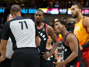 Toronto Raptors guard Kyle Lowry (second from right) argues with referee Rodney Mott (71) as Utah Jazz centre Rudy Gobert (far right) looks on during the last Raptors game before Gobert's positive COVID-19 test shut down the NBA. The Raptors are in Florida ahead of the league's anticipated restart.