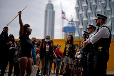 Protestors chant slogans s they  confront police officers outside the US Embassy during an anti-racism demonstration in London on June 3, 2020, after George Floyd, an unarmed black man died after a police officer knelt on his neck during an arrest in Minneapolis, USA. - Londoners defied coronavirus restrictions and rallied on Wednesday in solidarity with protests raging across the United States over the death of George Floyd, an unarmed black man who died during an arrest on May 25.