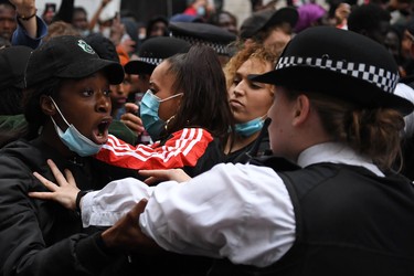 Protestors remonstrate with Police officers near the Foreign Office, during an anti-racism demonstration in London, on June 3, 2020, after George Floyd, an unarmed black man died after a police officer knelt on his neck during an arrest in Minneapolis, USA. - Thousands of people took to the streets of London on Wednesday to protest the death of George Floyd in US police custody, as Prime Minister Boris Johnson condemned the killing and told President Donald Trump that racist violence had "no place" in society. Protesters, many of them in face masks, defied coronavirus restrictions and held aloft signs saying "Justice for George Floyd" and "Enough is enough!" as they marched from Hyde Park to the Whitehall government district in central London.
