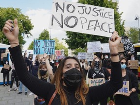 Demonstrators protest with banners against racism in front of the US embassy in Warsaw on June 4, 2020 in solidarity with protests raging across the United States over the death of George Floyd.