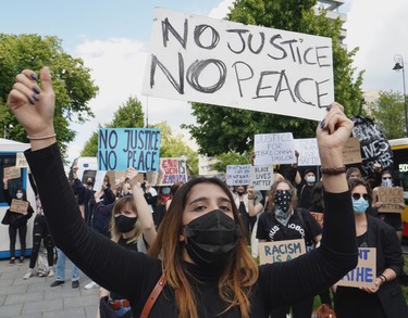 Demonstrators protest with banners against racism in front of the US embassy in Warsaw on June 4, 2020 in solidarity with protests raging across the United States over the death of George Floyd.