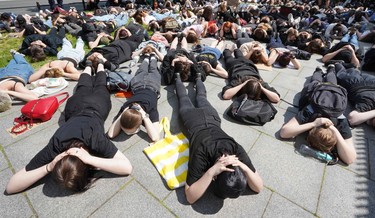 Demonstrators lie on the ground to protest against racism in front of the US embassy in Warsaw on June 4, 2020 in solidarity with protests raging across the United States over the death of George Floyd.