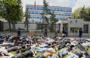 Demonstrators lie on the ground to protest against racism in front of the US embassy in Warsaw on June 4, 2020 in solidarity with protests raging across the United States over the death of George Floyd.