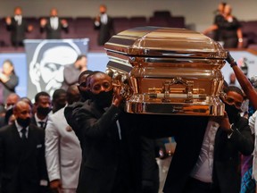 TOPSHOT - Pallbearers carry the casket following the funeral of George Floyd June 9, 2020, at The Fountain of Praise church in Houston. - George Floyd will be laid to rest Tuesday in his Houston hometown, the culmination of a long farewell to the 46-year-old African American whose death in custody ignited global protests against police brutality and racism. Thousands of well-wishers filed past Floyd's coffin in a public viewing a day earlier, as a court set bail at $1 million for the white officer charged with his murder last month in Minneapolis. (Photo by Godofredo A. VASQUEZ / POOL / AFP) (Photo by GODOFREDO A. VASQUEZ/POOL/AFP via Getty Images)