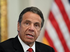 New York's governor has threatened to roll back phased reopening plans after large crowds gathered outside bars in New York City in violation of coronavirus lockdown guidelines.
