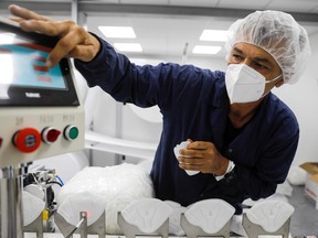 A worker at the Sion Medical factory produces an N95 mask.